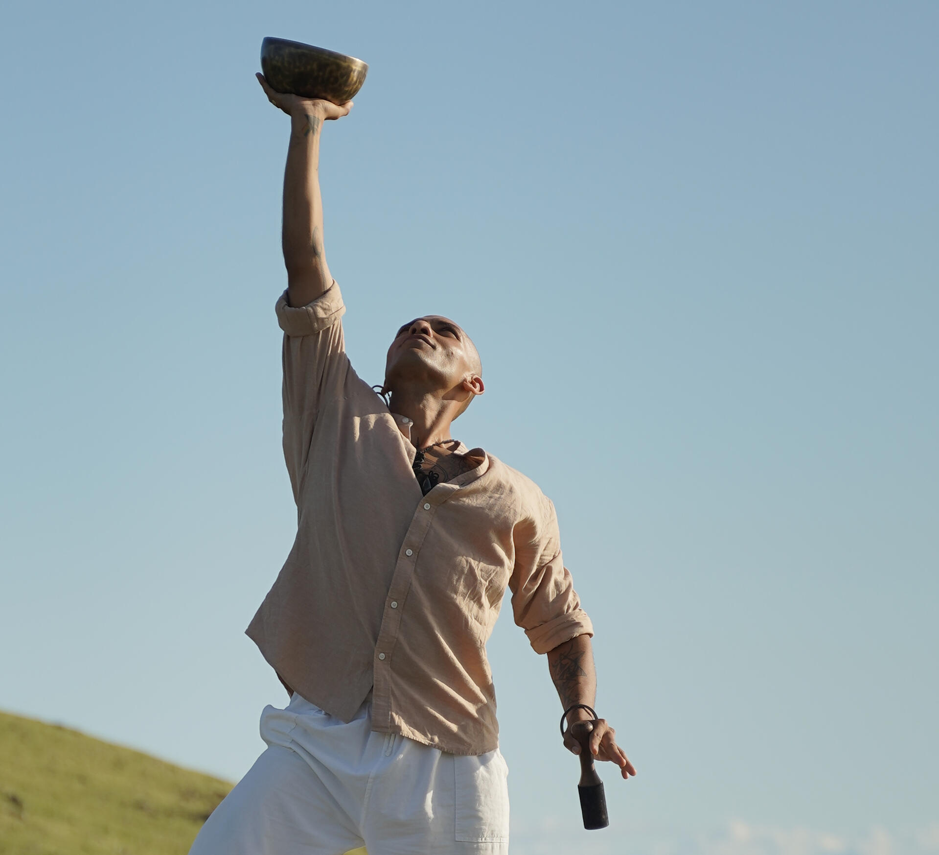 Holistic Coach Free Lopez with Tibetan Singing Bowl Holistic Coach and Sound Healing Faciliator Free Lopez with Tibetan Singing Bowl depicted in nature with sky as background