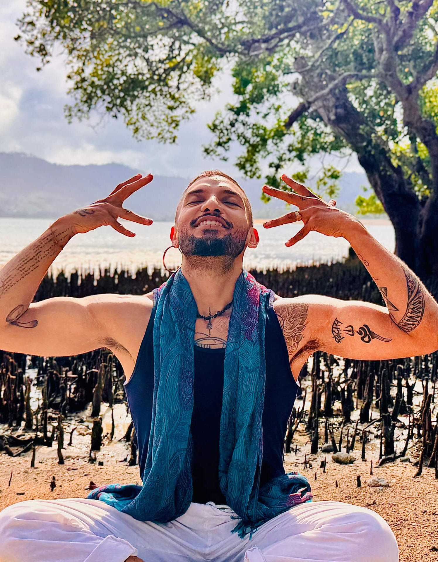 Meditation & Energy Work in Lombok Smiling holistic Reiki practitioner and movement faciliator Free Lopez practicing Reiki energy healing and meditative movement by the sea in Lombok, Indonesia